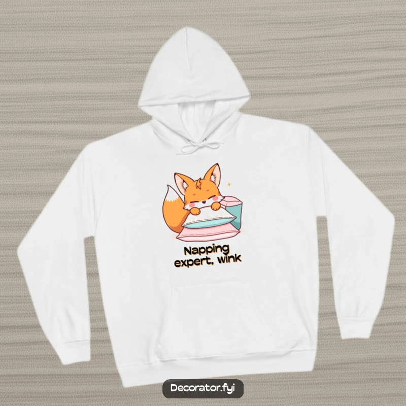 Funny hoodie featuring a mischievous fox character creating a playful pile of cushions with a knowing wink.
