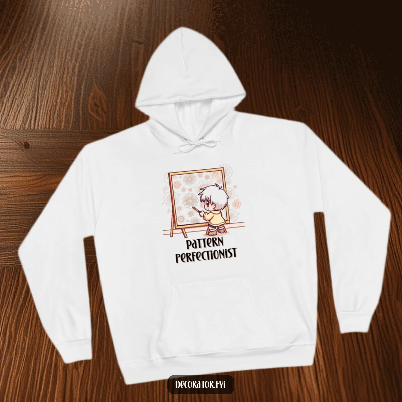Funny hoodie featuring a determined character meticulously painting intricate patterns onto a wall, perfect for artisans and hobbyists.