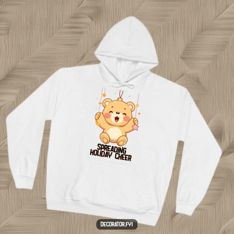 Funny bear cub enthusiastically hanging shiny ornaments, depicted on a soft, warm hoodie, ideal for cozy holiday wear.